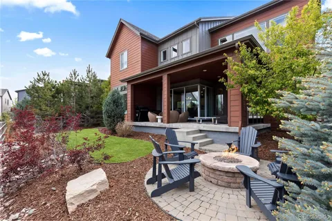 a view of a house with backyard and sitting area