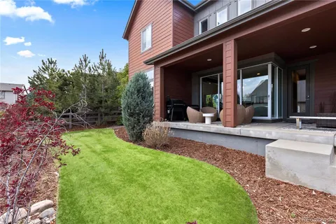 a view of a house with backyard porch and furniture