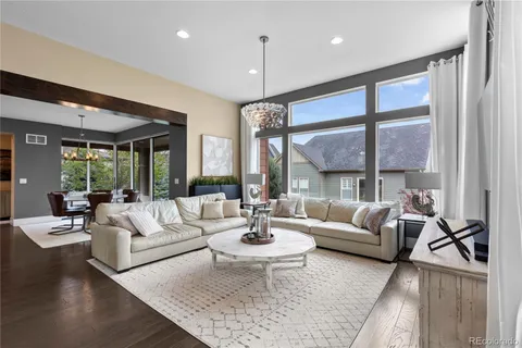 a living room with fireplace furniture and a large window