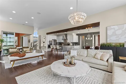 a living room with furniture couches and a large mirror on the table