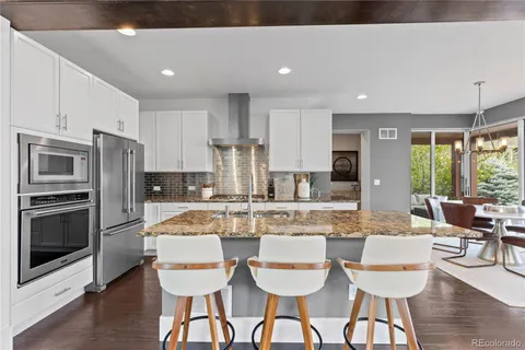 a large kitchen with a table and chairs