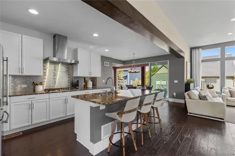 a kitchen with granite countertop white cabinets and white appliances