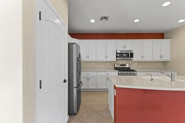 a kitchen with stainless steel appliances granite countertop a refrigerator sink and cabinets