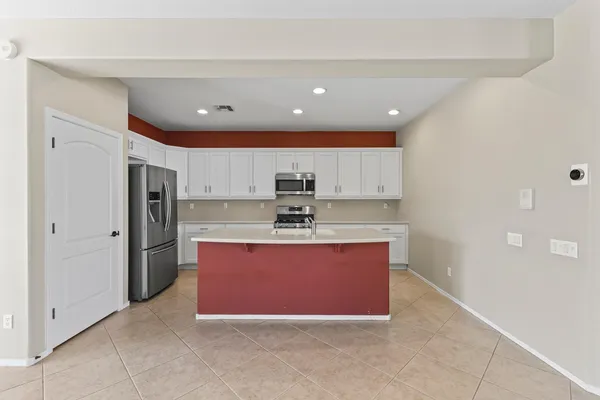 a view of kitchen with stainless steel appliances granite countertop refrigerator sink and stove