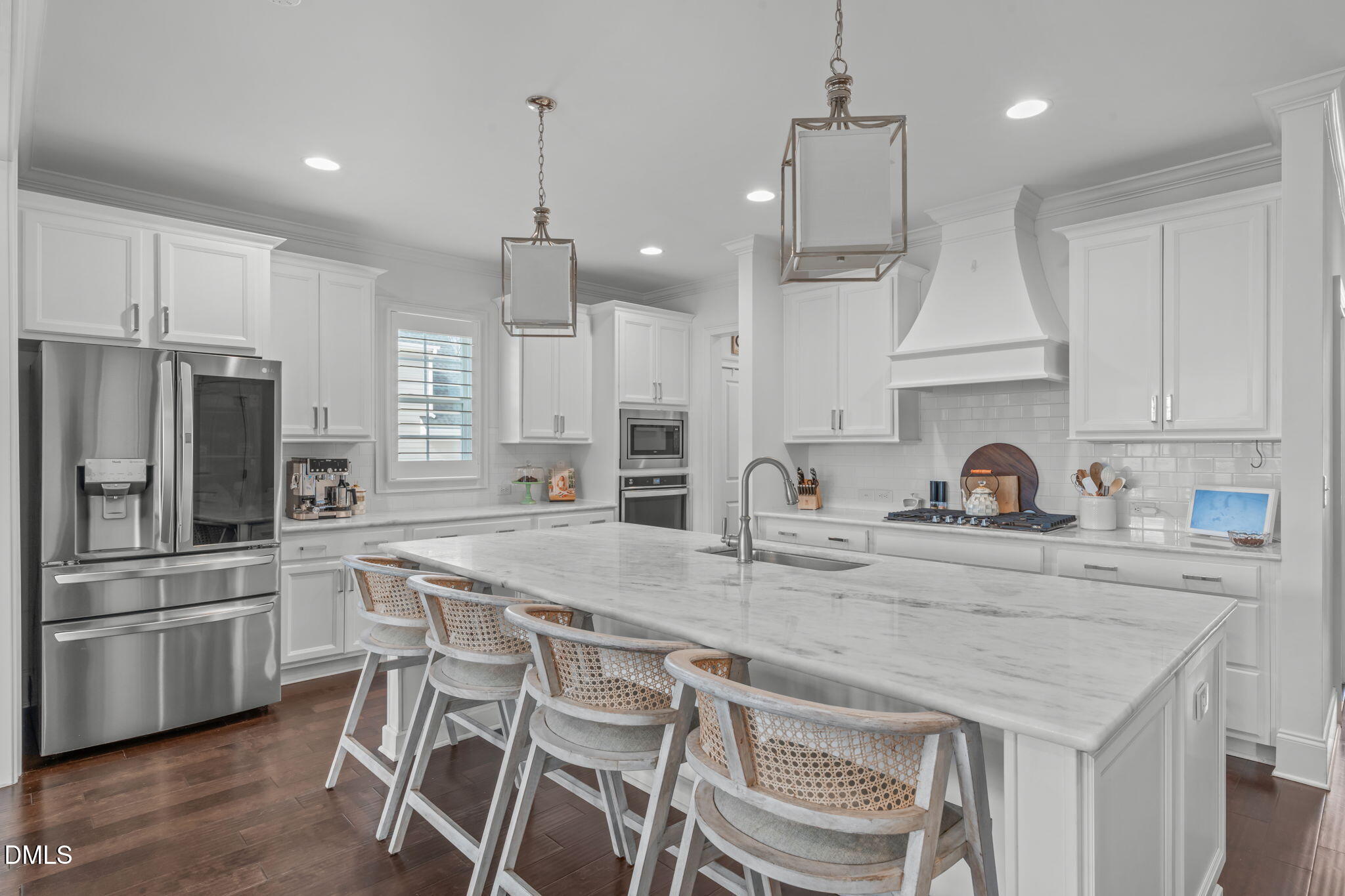 4144 Olde Judd Drive Willow Spring, NC 27592 - Photo 8 of 52 a kitchen with white cabinets and stainless steel appliances