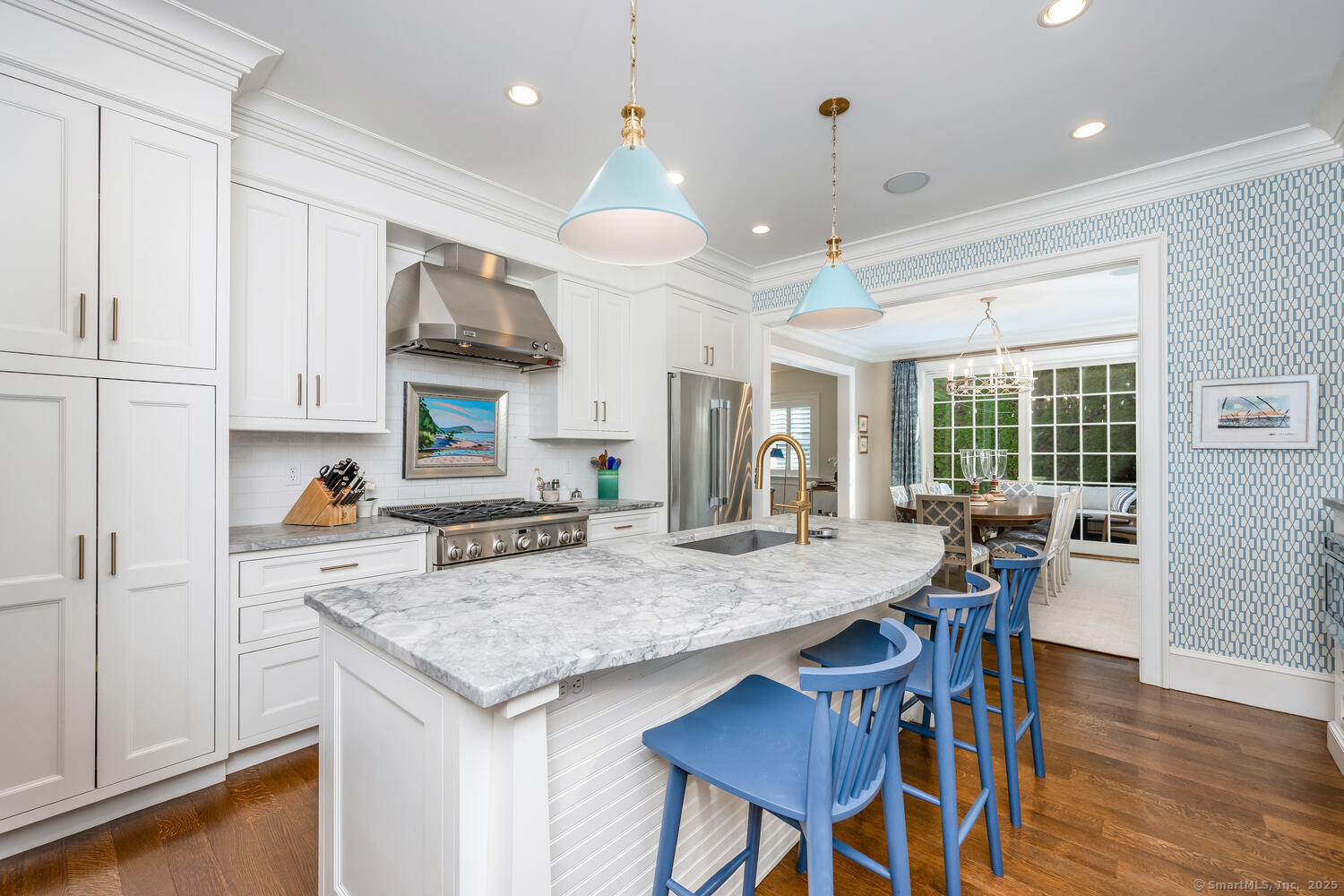 333 West Avenue, Unit 3 Darien, CT 06820 - Photo 13 of 38 a kitchen with granite countertop a table chairs stove and wooden floor