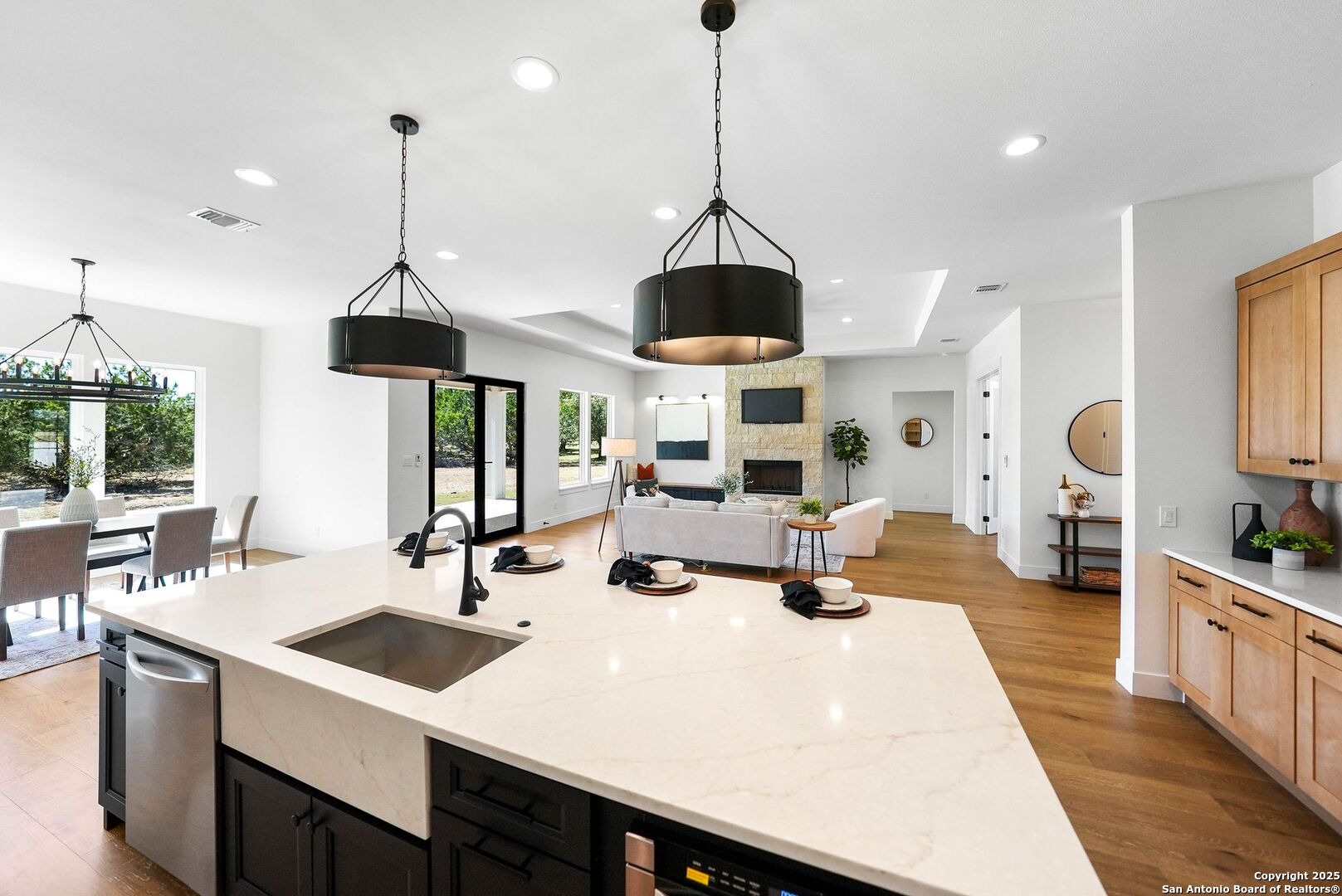 414 Rio Azul Drive Pipe Creek, TX 78063 - Photo 11 of 51 a kitchen with stainless steel appliances a sink a center island and a wooden floors