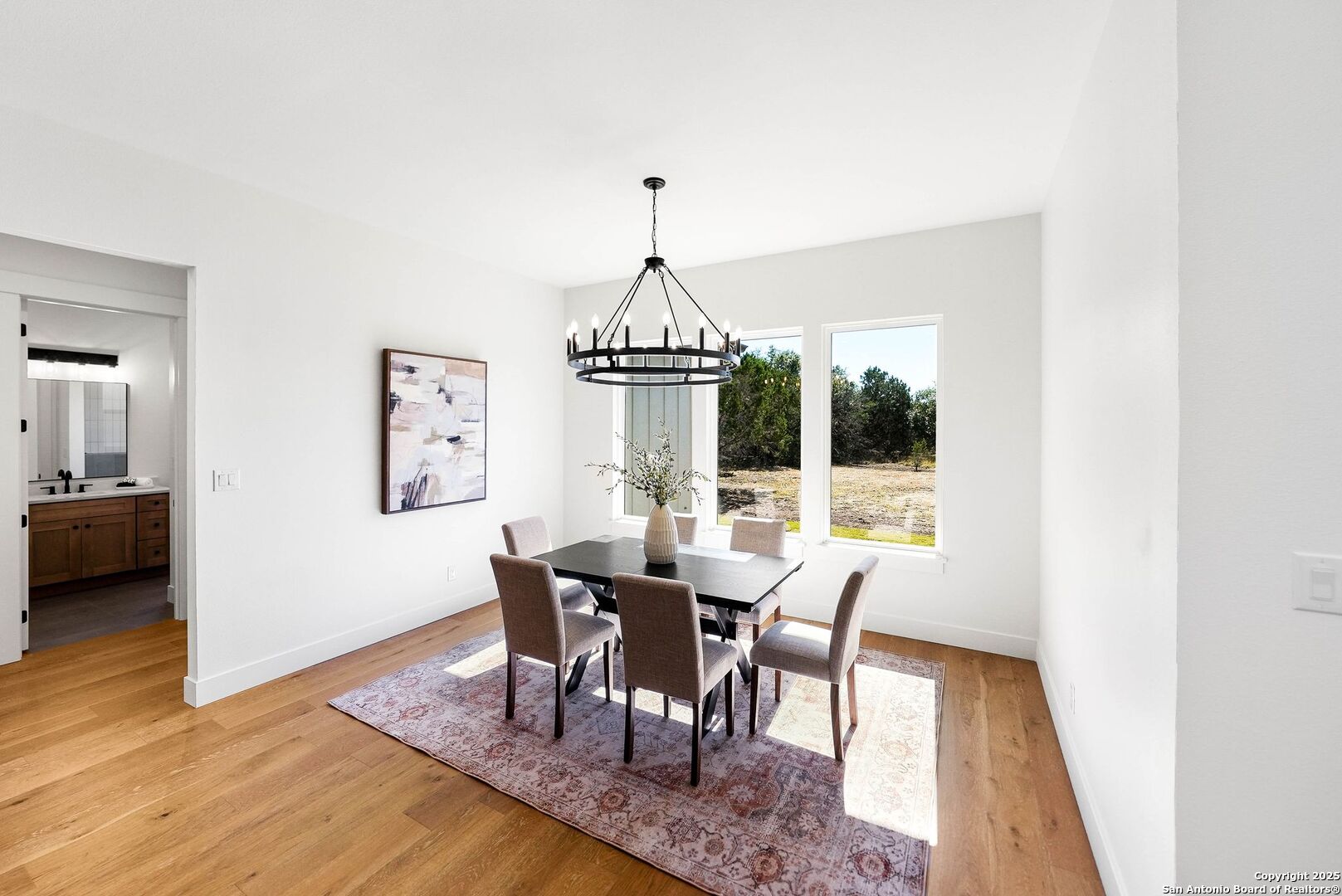 414 Rio Azul Drive Pipe Creek, TX 78063 - Photo 15 of 51 a view of a dining room with furniture window and wooden floor