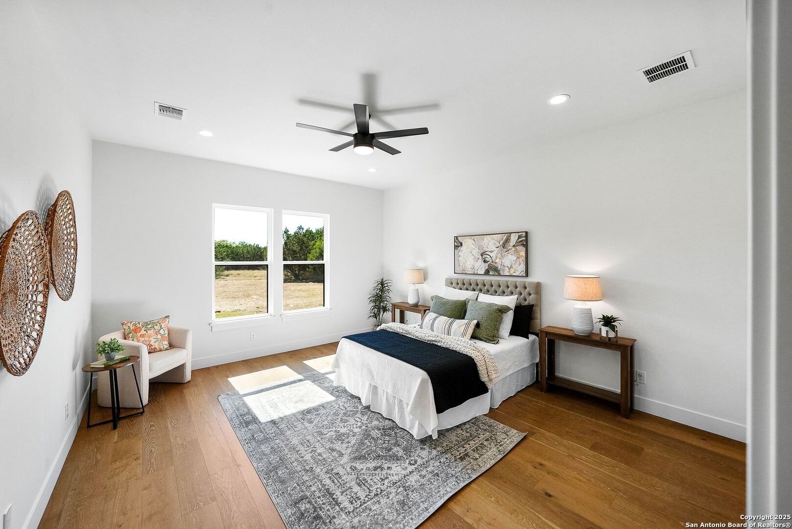 414 Rio Azul Drive Pipe Creek, TX 78063 - Photo 20 of 51 a bedroom with a bed and wooden floor