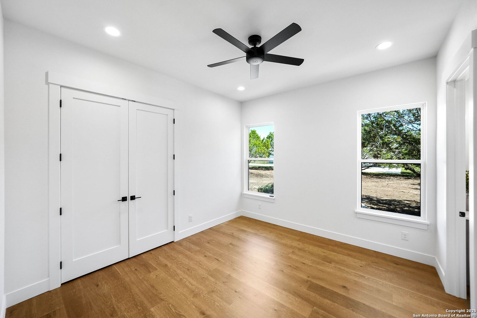 414 Rio Azul Drive Pipe Creek, TX 78063 - Photo 34 of 51 an empty room with wooden floor and windows