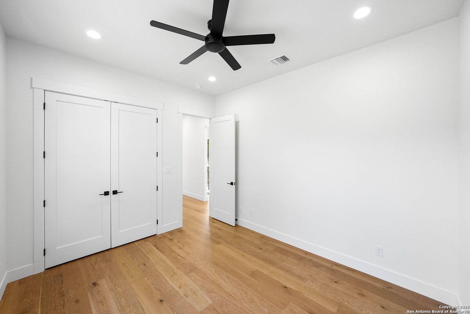 414 Rio Azul Drive Pipe Creek, TX 78063 - Photo 39 of 51 an empty room with wooden floor and ceiling fan