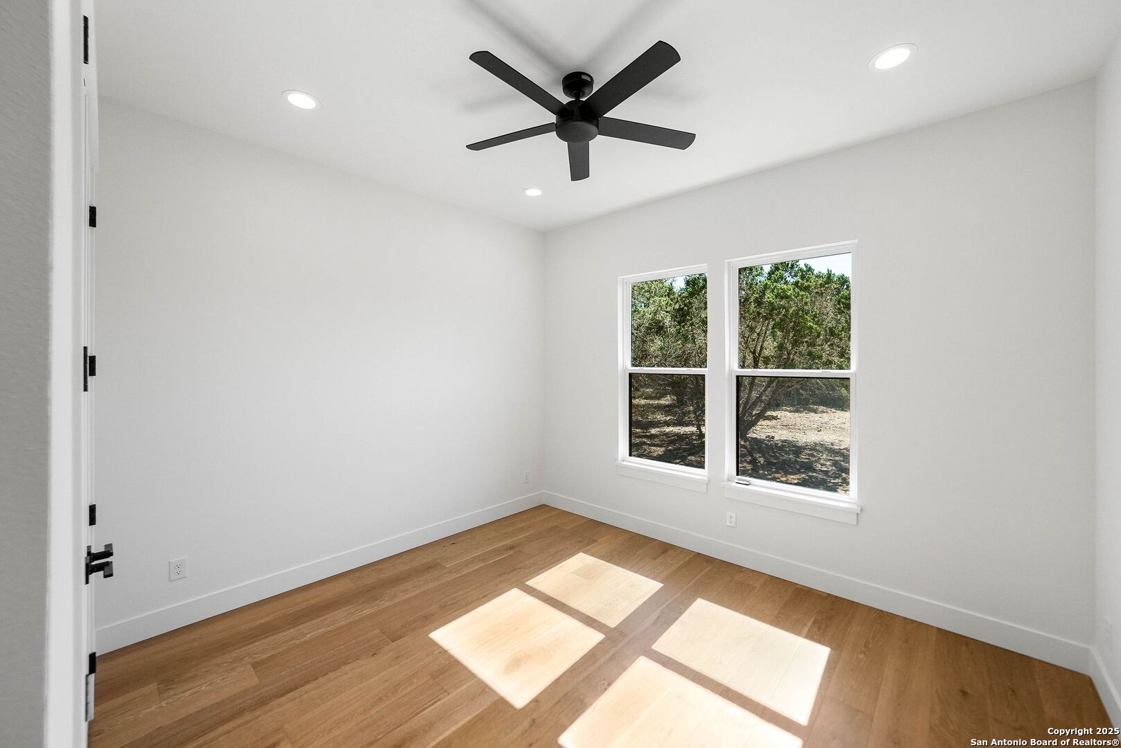414 Rio Azul Drive Pipe Creek, TX 78063 - Photo 40 of 51 an empty room with wooden floor and windows