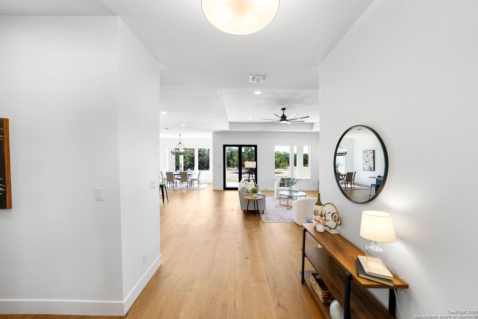 414 Rio Azul Drive Pipe Creek, TX 78063 - Photo 4 of 51 a view of a livingroom with furniture wooden floor a rug and a large window