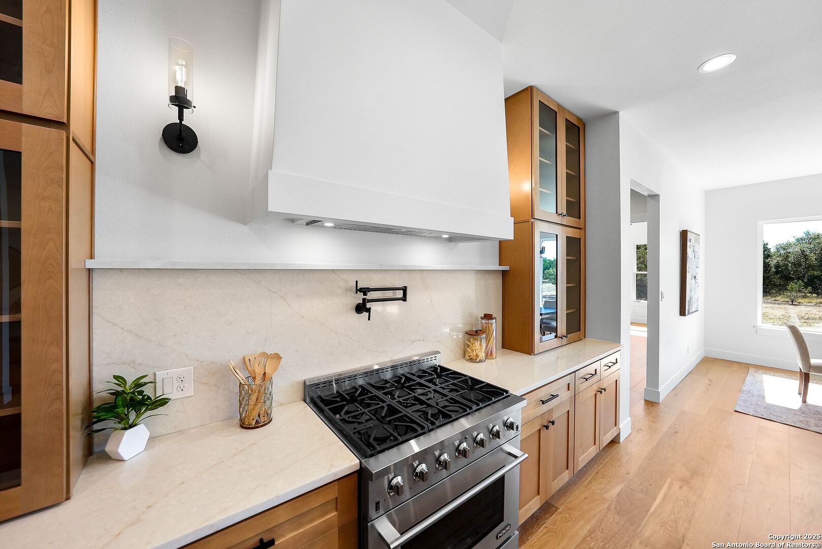 414 Rio Azul Drive Pipe Creek, TX 78063 - Photo 9 of 51 a kitchen with granite countertop a stove and a view of living room