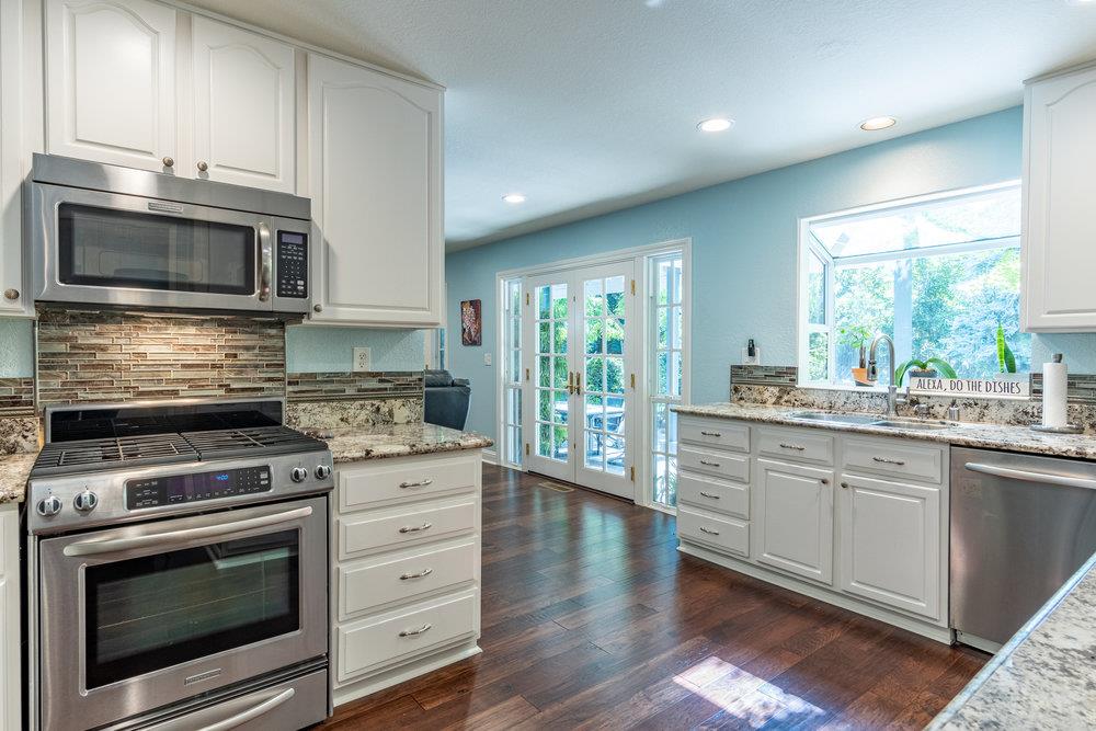 8955 Ridgeway Drive Gilroy, CA 95020 - Photo 15 of 64 a kitchen with stainless steel appliances a stove microwave and sink