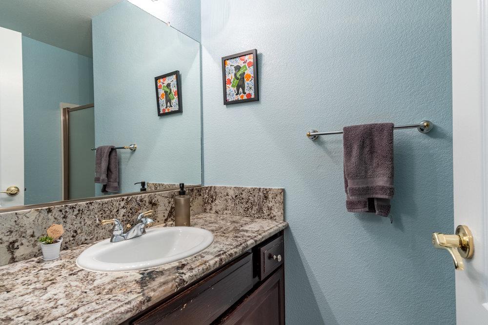 8955 Ridgeway Drive Gilroy, CA 95020 - Photo 22 of 64 a bathroom with a granite countertop sink and a mirror