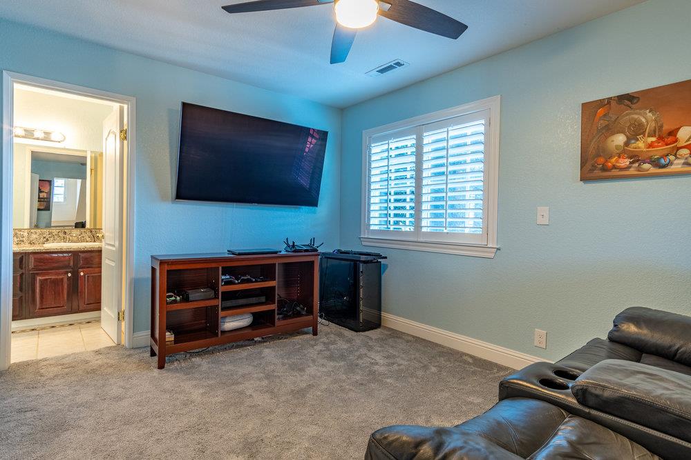 8955 Ridgeway Drive Gilroy, CA 95020 - Photo 36 of 64 a living room with furniture and a flat screen tv
