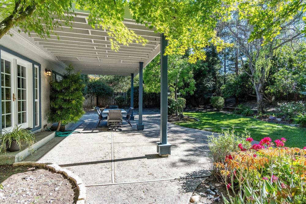 8955 Ridgeway Drive Gilroy, CA 95020 - Photo 41 of 64 a view of a patio with table and chairs potted plants and floor to ceiling window