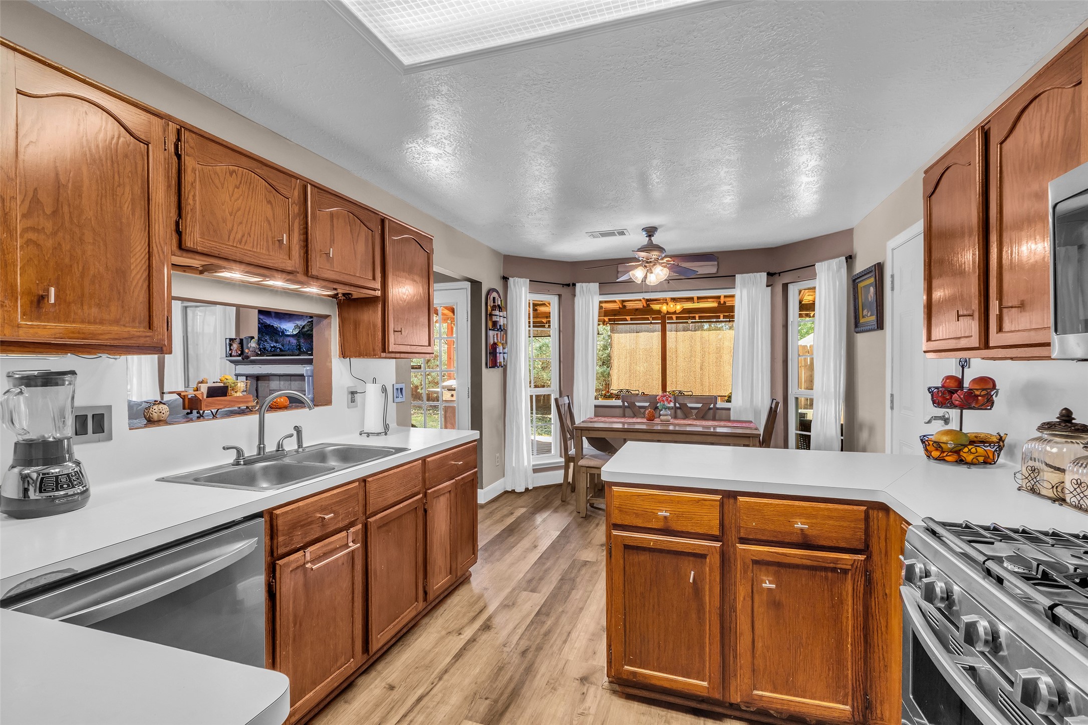 21303 Deerhaven Drive Spring, TX 77388 - Photo 11 of 24 a kitchen with stainless steel appliances granite countertop a sink stove and cabinets