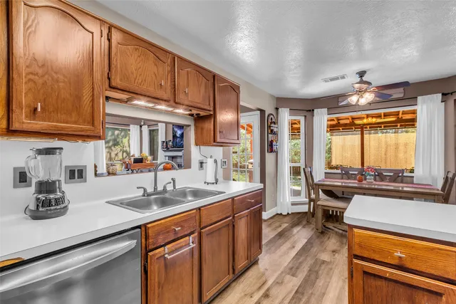 a kitchen with stainless steel appliances a sink stove and cabinets