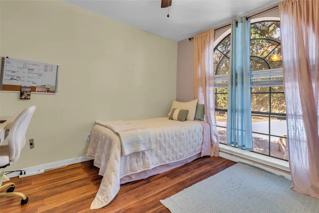a bedroom with a bed and wooden floor