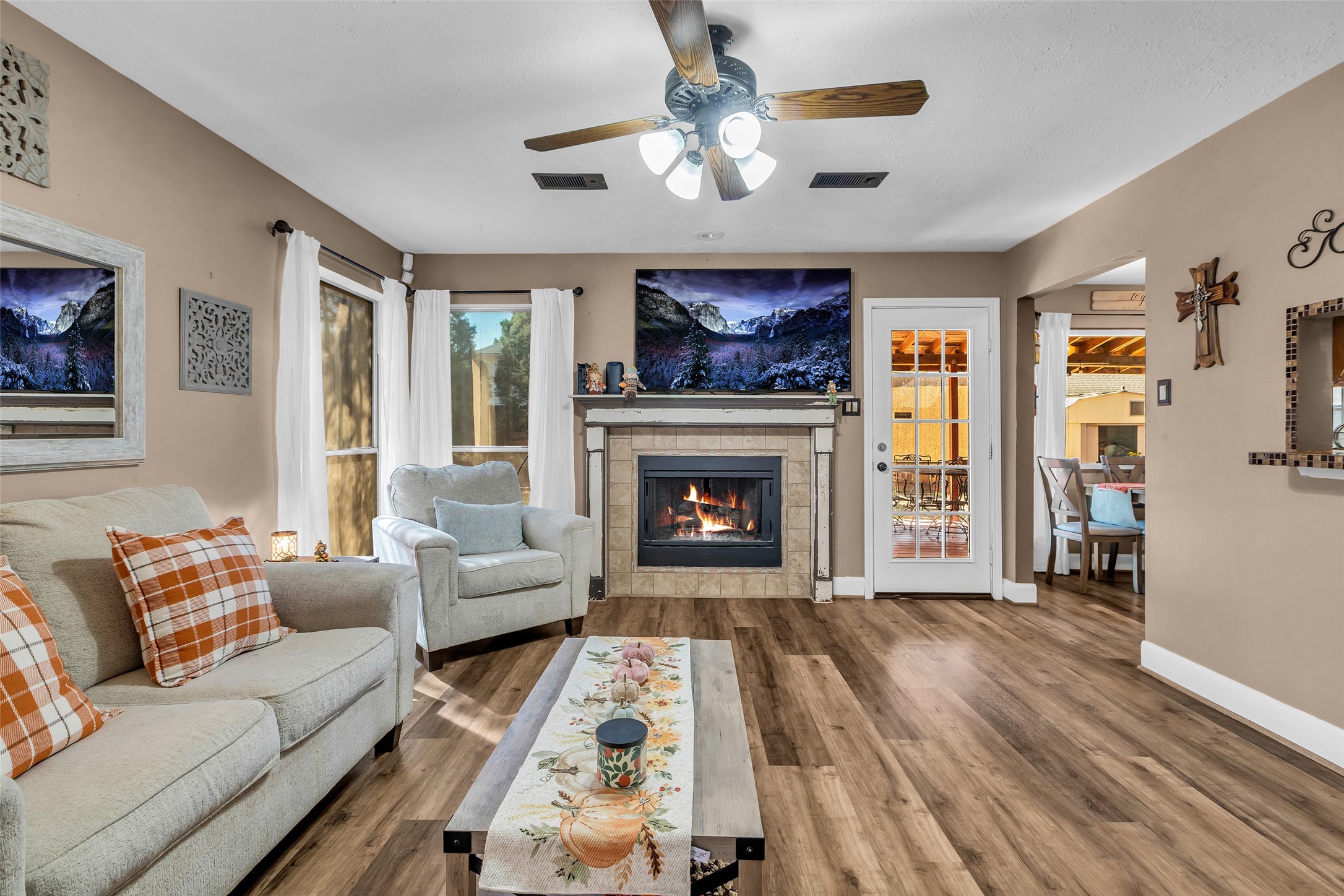 21303 Deerhaven Drive Spring, TX 77388 - Photo 6 of 24 a living room with furniture a fireplace and a flat screen tv