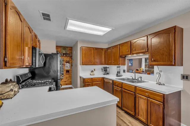 a kitchen with a sink stove and cabinets