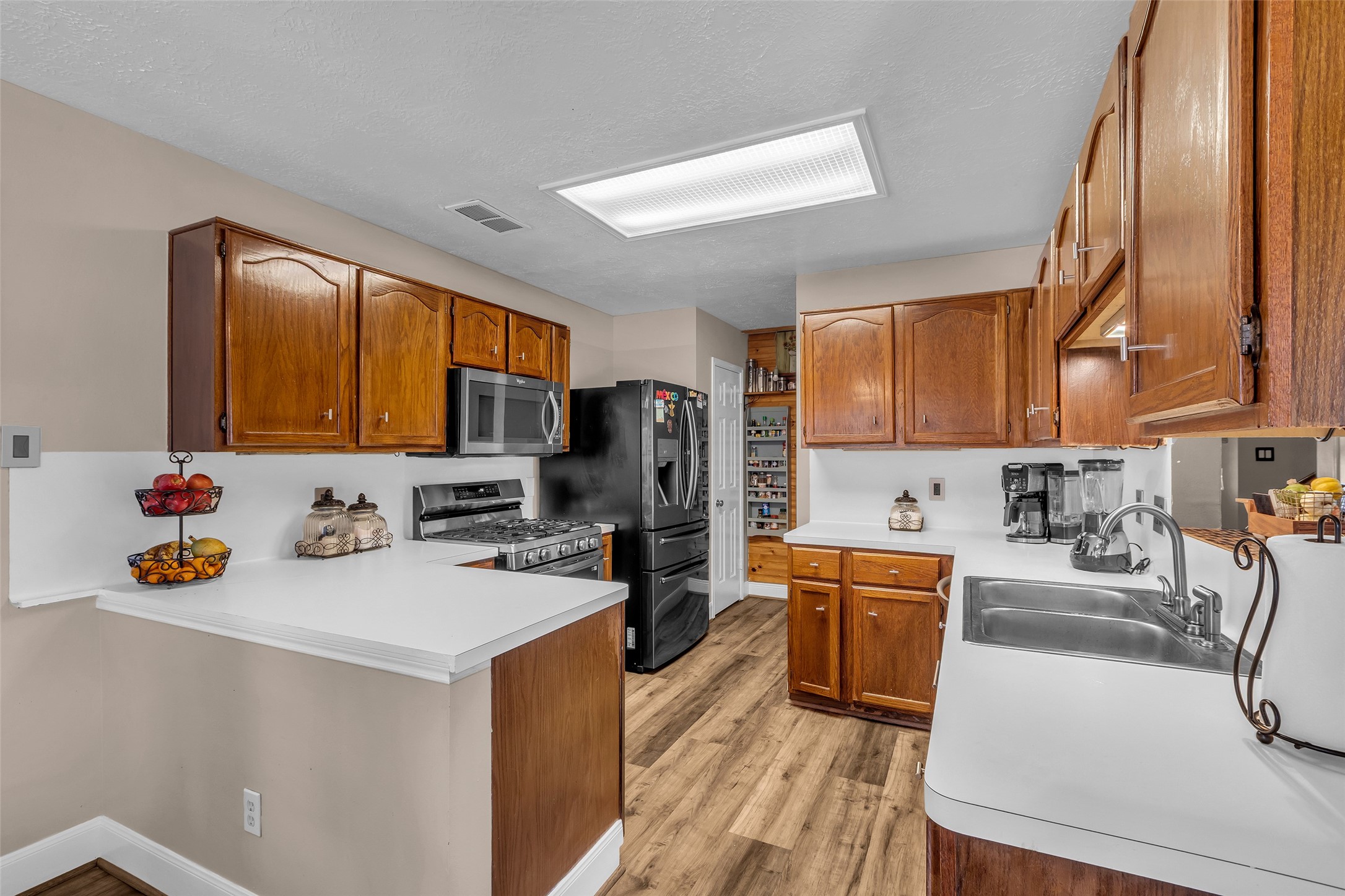 21303 Deerhaven Drive Spring, TX 77388 - Photo 10 of 24 a kitchen that has a sink a stove and chairs