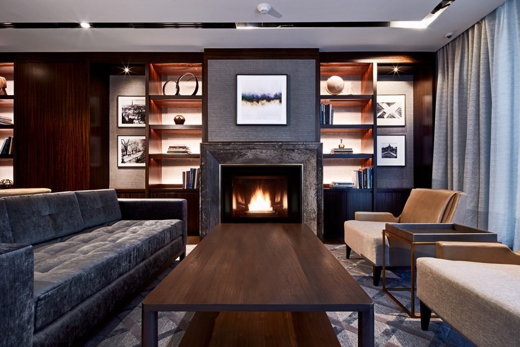 133 Seaport Boulevard, Unit 823 Boston, MA 02210 - Photo 18 of 30 a living room with furniture and a fireplace