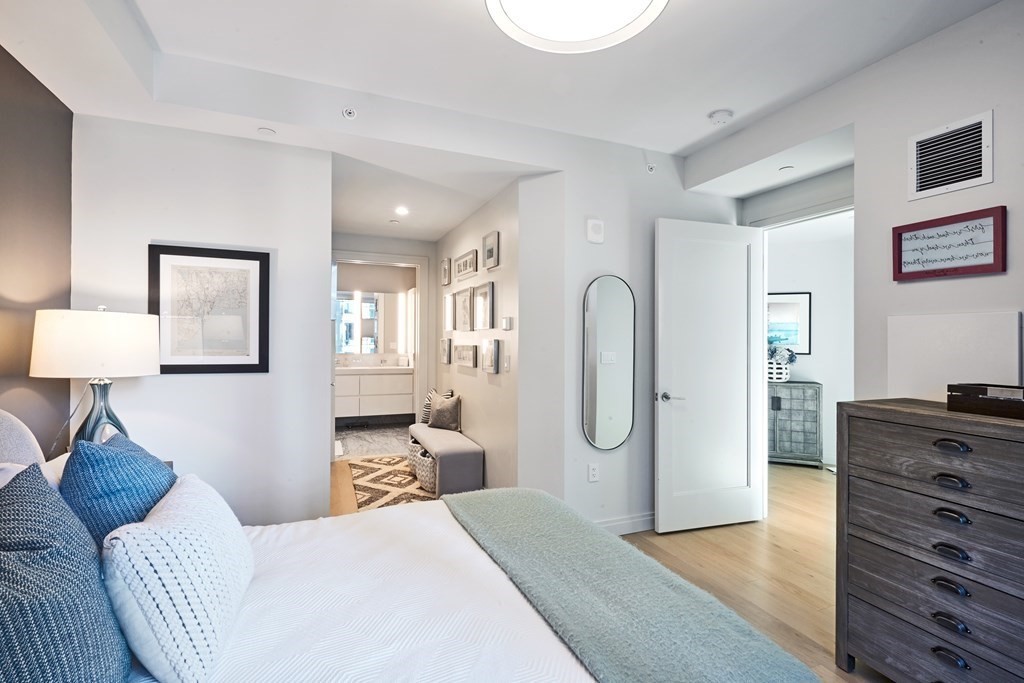 133 Seaport Boulevard, Unit 823 Boston, MA 02210 - Photo 8 of 30 a bedroom with a bed and wooden floor
