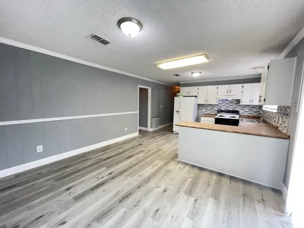 a kitchen with stainless steel appliances granite countertop a stove and a refrigerator
