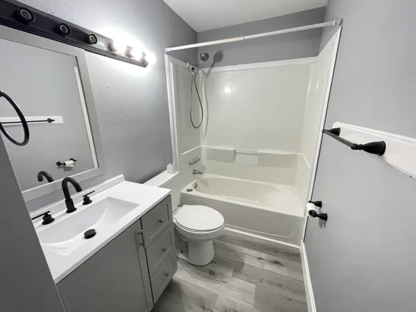 a bathroom with a sink mirror toilet and shower