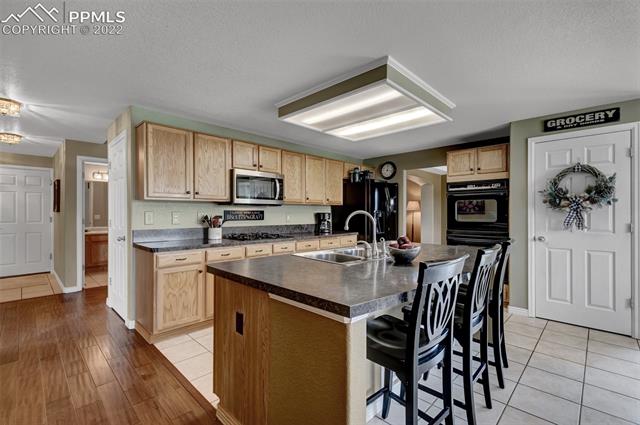8460 Tibbs Road Peyton, CO 80831 - Photo 11 of 37 Island with Seating