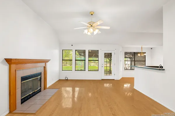 a view of an empty room with a fireplace and a window