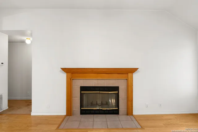a an empty room with a fireplace