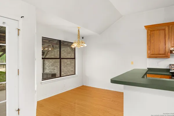 a bedroom with a bed and a dresser with mirror