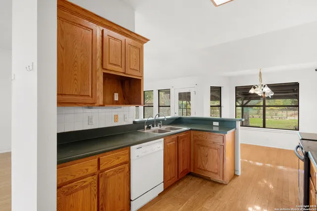 a kitchen with stainless steel appliances granite countertop a sink and cabinets