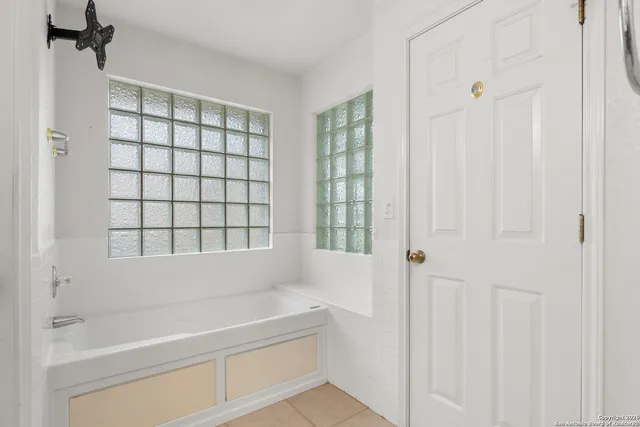 a bathroom with a bathtub and a shower