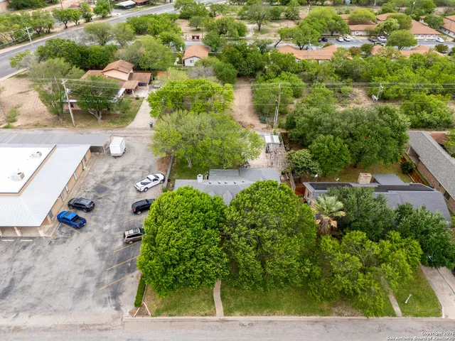 an aerial view of a house with a yard and garden
