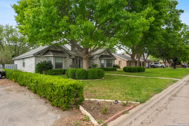 a front view of house with yard and green space