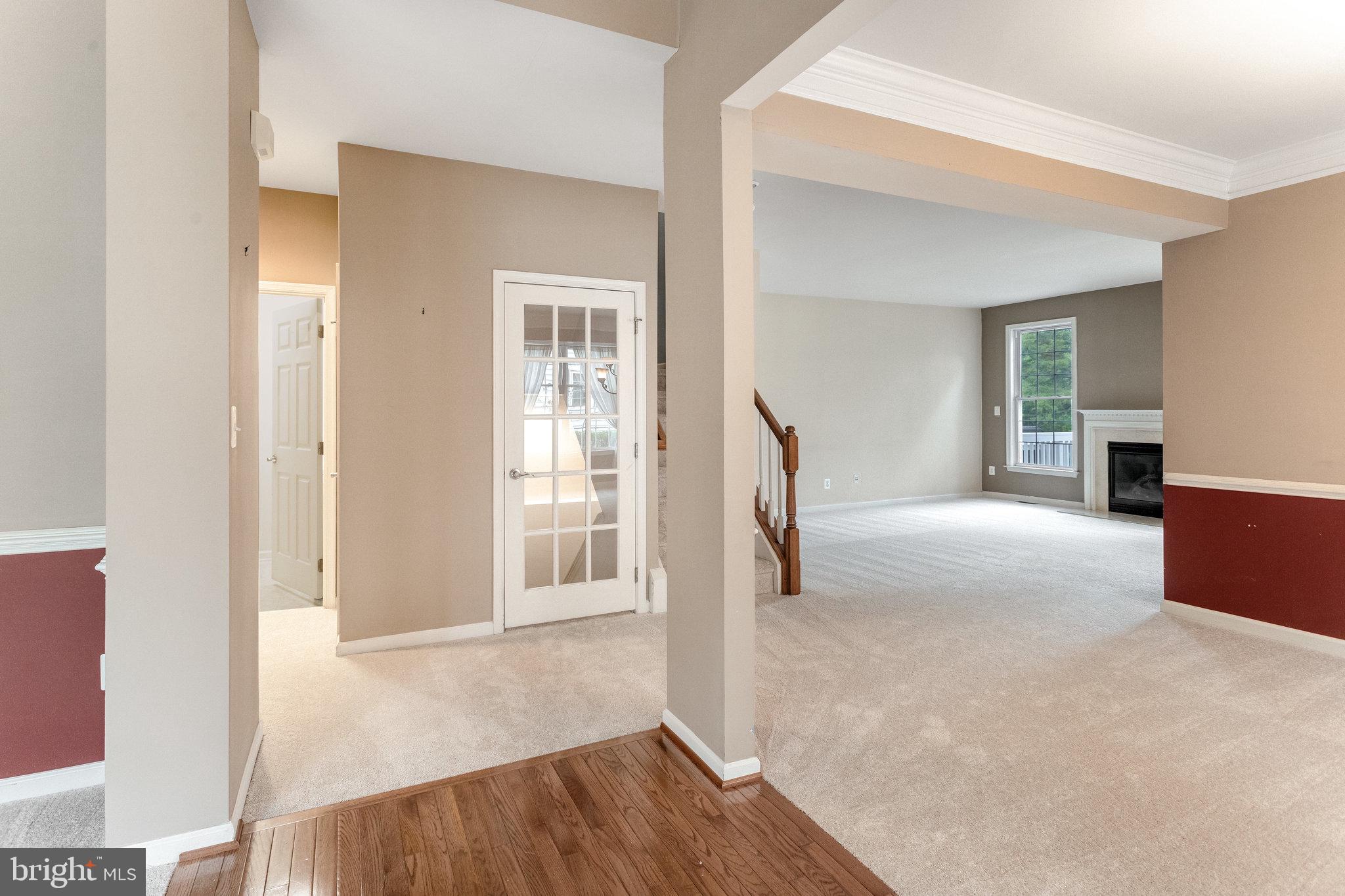 5608 Wheelwright Way Haymarket, VA 20169 - Photo 18 of 88 Staircase to upper level and glass door to lwr lvl