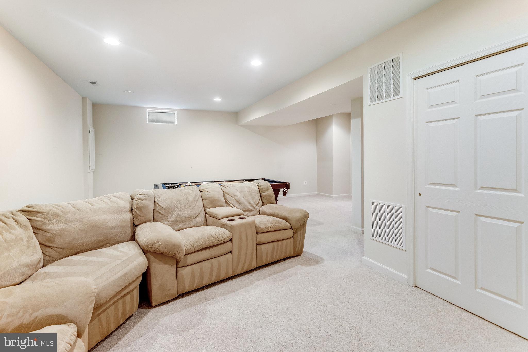 5608 Wheelwright Way Haymarket, VA 20169 - Photo 35 of 88 Lower level family room-sectional conveys