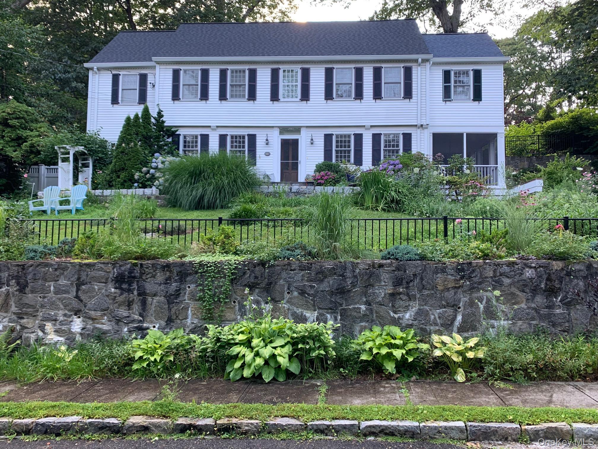 a front view of a house with a garden