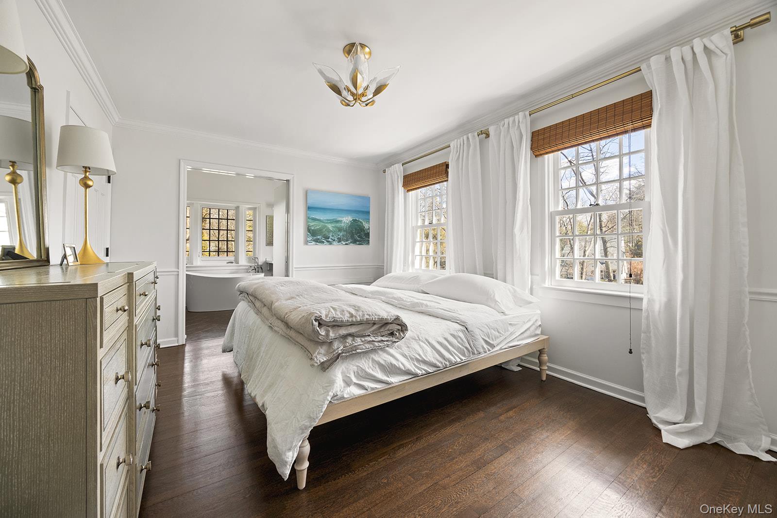 147 Valley Stream Road East Larchmont, NY 10538 - Photo 12 of 37 a spacious bedroom with a bed and a chandelier