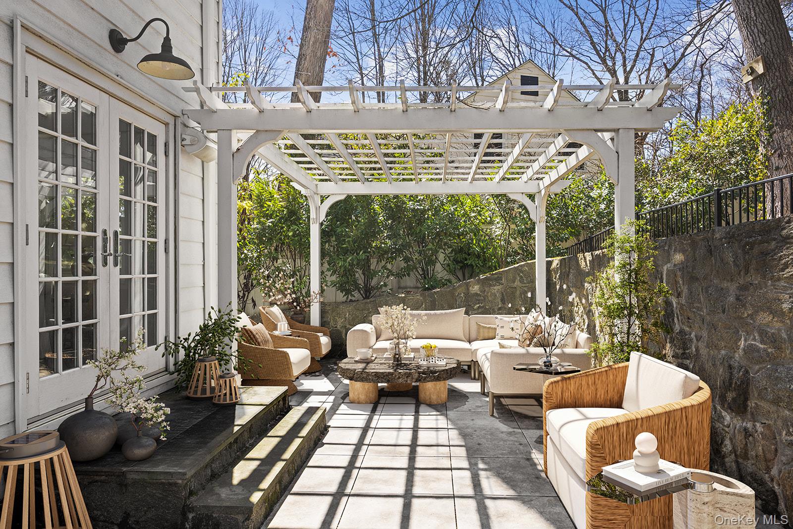 147 Valley Stream Road East Larchmont, NY 10538 - Photo 30 of 37 a view of a patio with couches table and chairs and potted plants