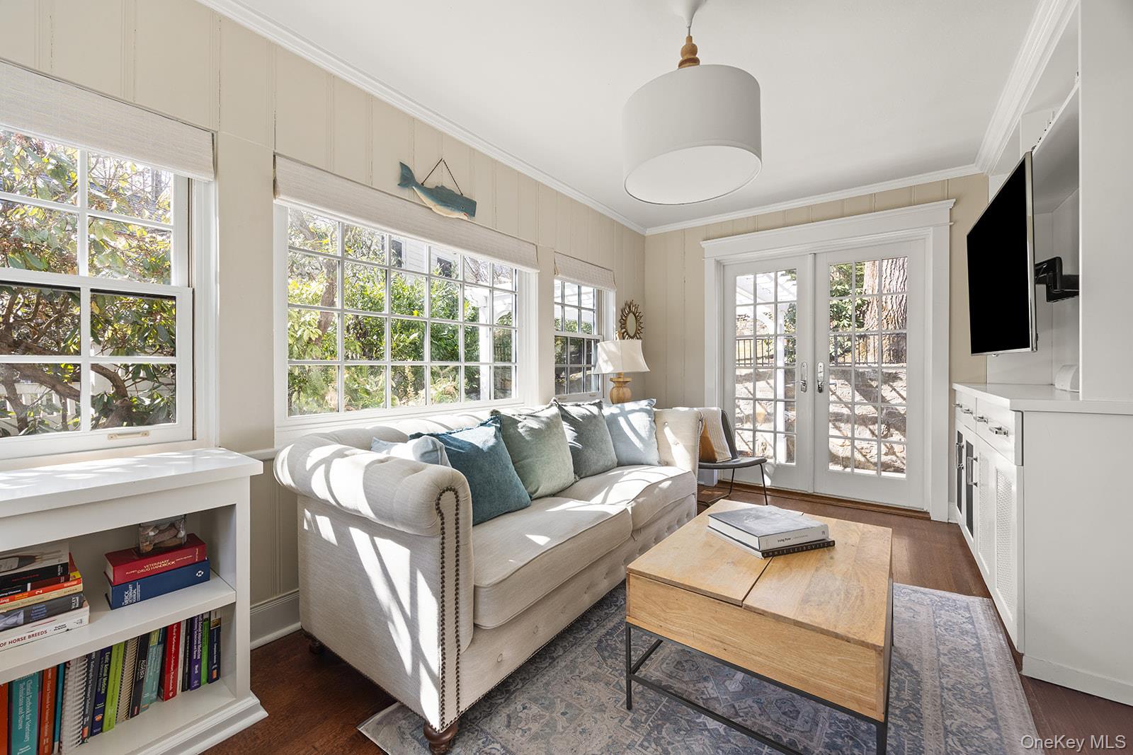 147 Valley Stream Road East Larchmont, NY 10538 - Photo 3 of 37 a living room with furniture a flat screen tv and a large window