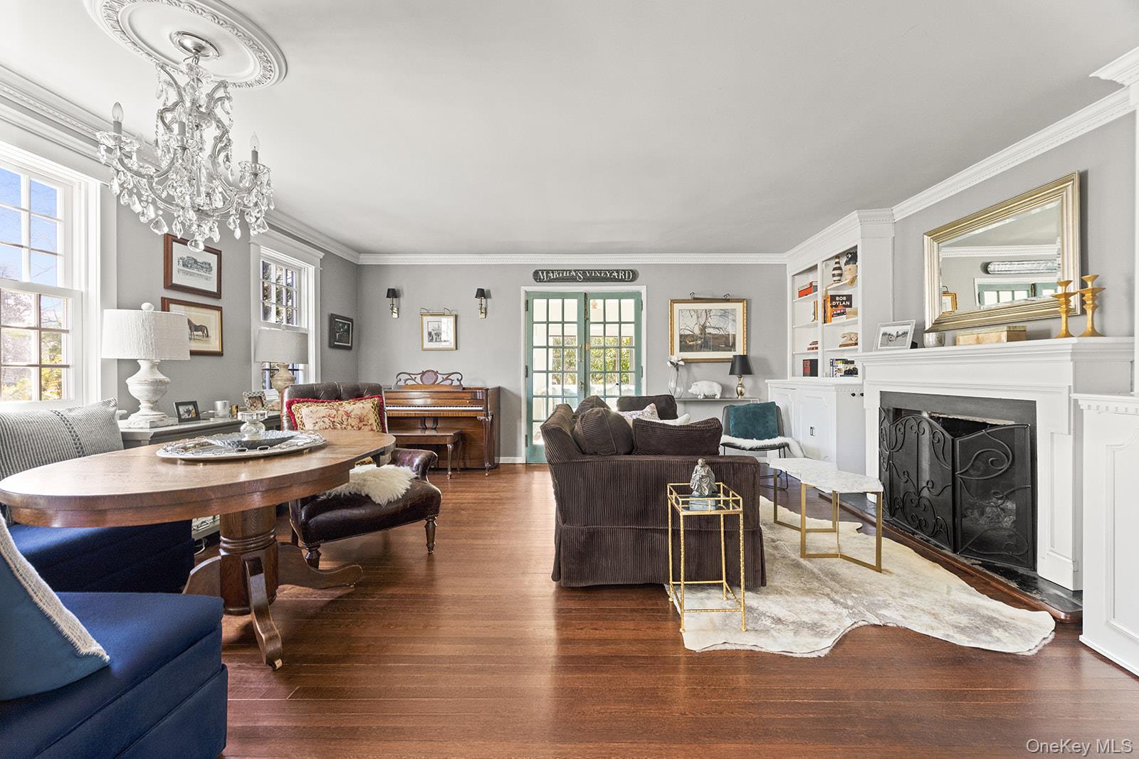 147 Valley Stream Road East Larchmont, NY 10538 - Photo 9 of 37 a living room with furniture a fireplace and a chandelier