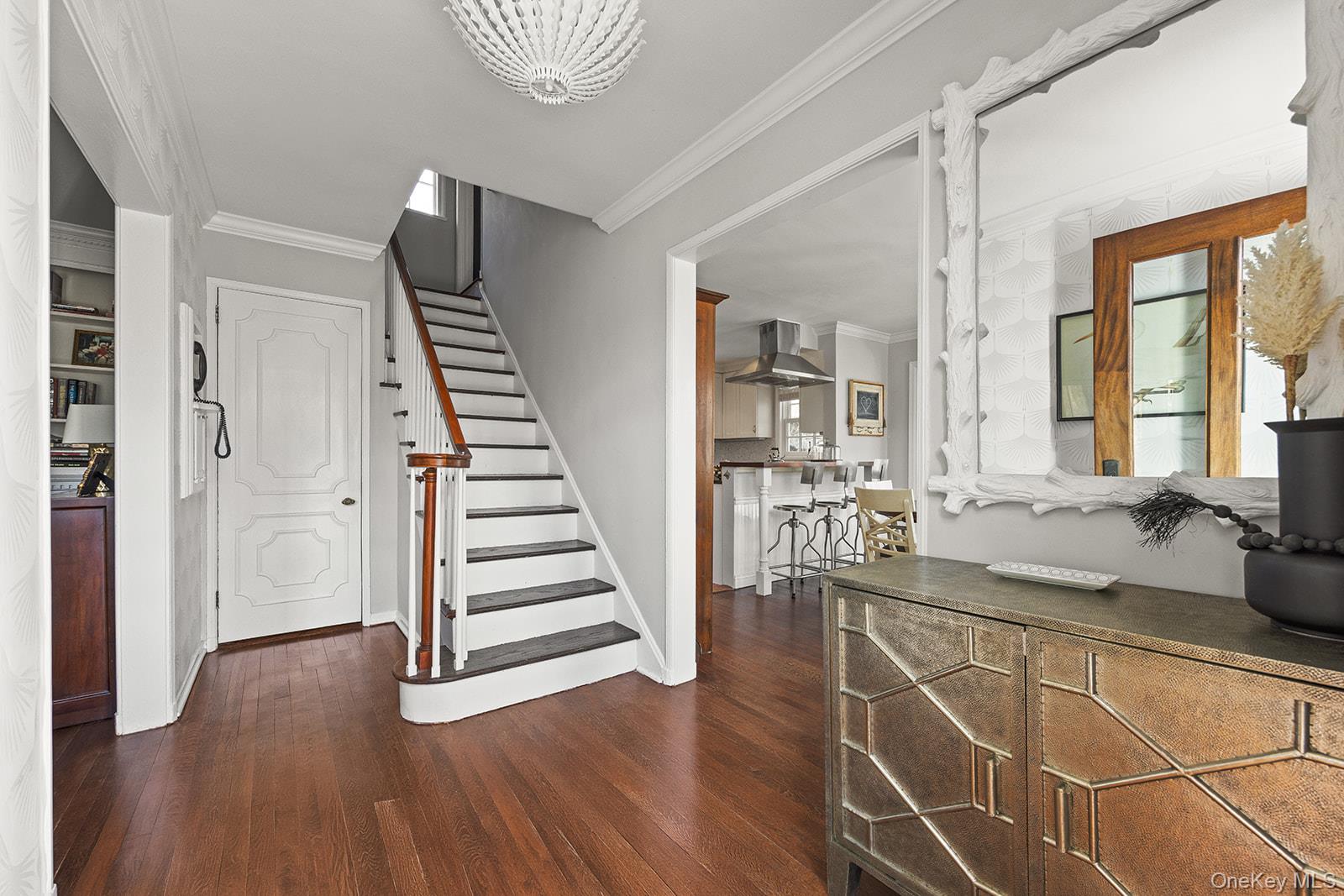 147 Valley Stream Road East Larchmont, NY 10538 - Photo 10 of 37 a view of a hallway with wooden floor and staircase