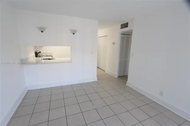 a kitchen with a sink a microwave and cabinets
