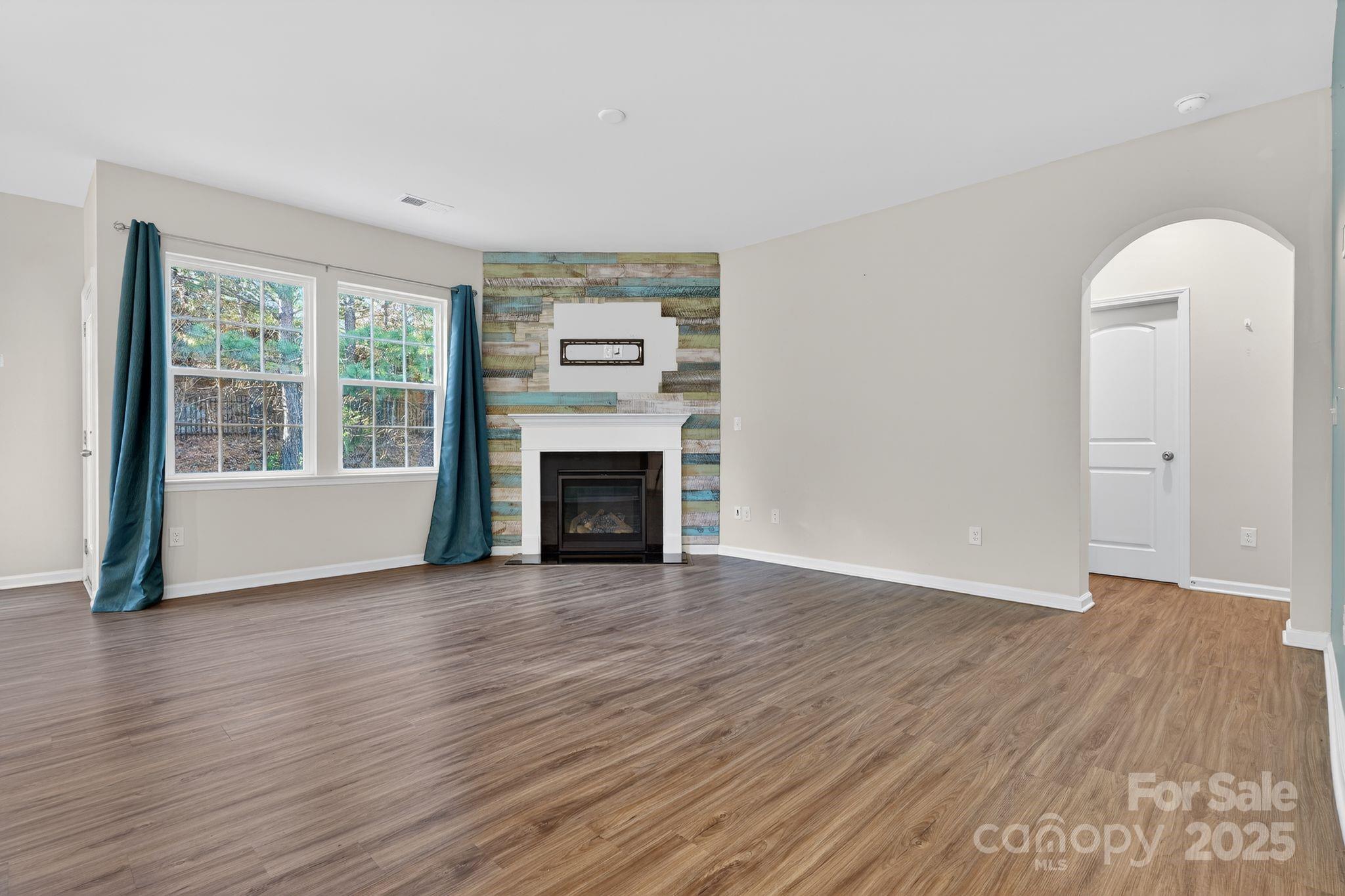 130 Dry Rivers Lane Mooresville, NC 28117 - Photo 5 of 30 a view of an empty room with wooden floor and a window